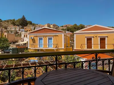 a view of a city from a balcony at Symi Garden Studios in Symi