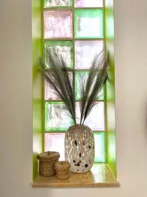 a vase sitting on a shelf in front of a window at Summer Breeze Villa in Afantou