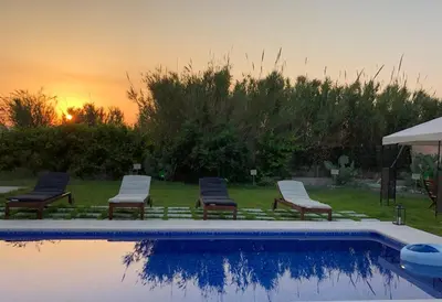 a group of chairs sitting next to a swimming pool at Summer Breeze Villa in Afantou