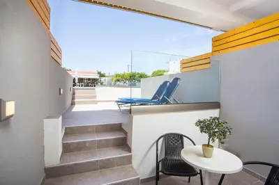 a view from the balcony of a house with a table and chairs at Tsampika Hotel Faliraki in Faliraki