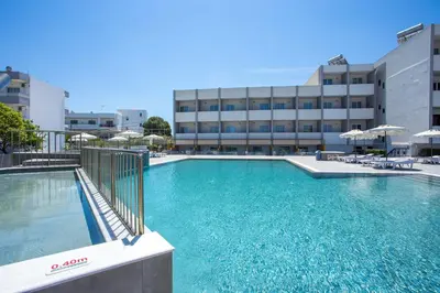 a large swimming pool in front of a building at Tsampika Hotel Faliraki in Faliraki