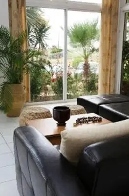 a living room with a couch and a table at Rhodian Sun Hotel in Paradeísion