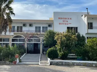 a building with a sign that reads rhodonian gin hotel at Rhodian Sun Hotel in Paradeísion