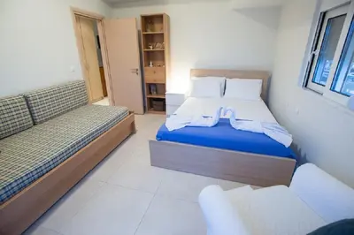 a small bedroom with two beds and a window at Zelos Rhodian House in Rhodes Town