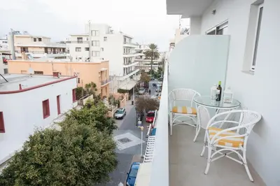 a balcony with a table and chairs and a city at Zelos Rhodian House in Rhodes Town