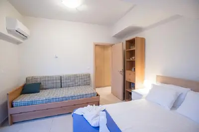a bedroom with a bed and a couch in it at Zelos Rhodian House in Rhodes Town