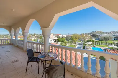 a balcony with a table and chairs and a view at Evelyn Villa in Archangelos