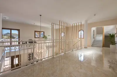 a large hallway with a staircase in a house at Evelyn Villa in Archangelos