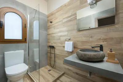 a bathroom with a sink and a toilet at Evelyn Villa in Archangelos
