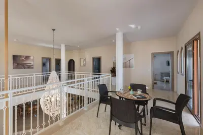 a dining room with a table and chairs at Evelyn Villa in Archangelos
