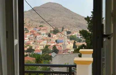 a view of a town from a window at Villa Cassandra in Halki