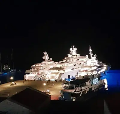 a large white yacht parked in a dock at night at Villa Cassandra in Halki