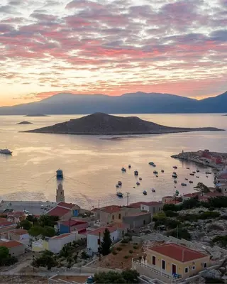 a view of a town with boats in the water at Villa Cassandra in Halki