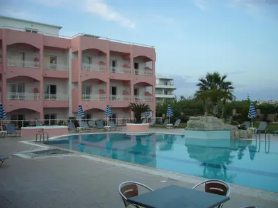 a hotel with a swimming pool in front of a building at Rhodian Rose Hotel in Faliraki