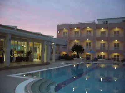 a hotel with a swimming pool in front of a building at Rhodian Rose Hotel in Faliraki