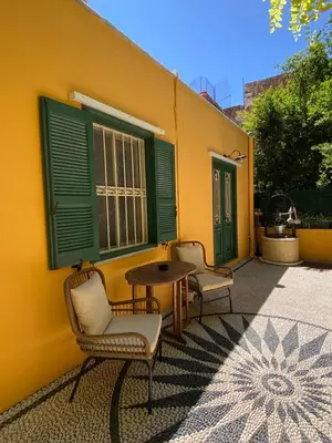 two chairs and a table in front of a building at Maison Masse - Historic Residence with Private Courtyard in Rhodes Town
