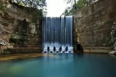 three birds standing in front of a waterfall at Maison Masse - Historic Residence with Private Courtyard in Rhodes Town