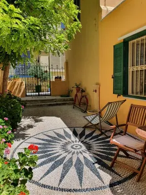 a patio with two chairs and a rug at Maison Masse - Historic Residence with Private Courtyard in Rhodes Town
