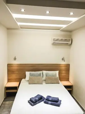 a bedroom with a bed with two towels on it at Omiros in Faliraki