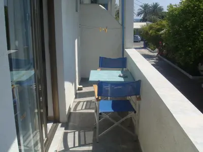 a table and chairs sitting on the side of a building at Omiros in Faliraki