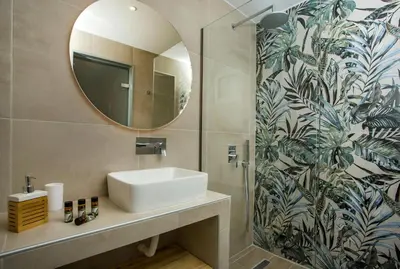 a bathroom with a sink and a mirror at CasaStavris - Aparts & Pool Suites in Faliraki