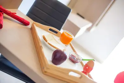 a lunch box with a tray of food and a drink at CasaStavris - Aparts & Pool Suites in Faliraki