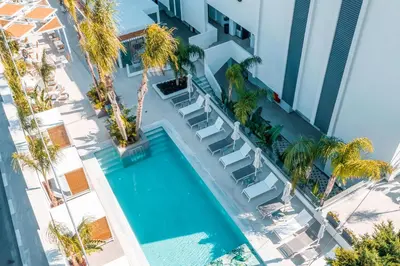 an overhead view of a hotel with a swimming pool and palm trees at CasaStavris - Aparts & Pool Suites in Faliraki
