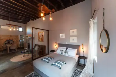 a bedroom with a bed and a living room at Colours - Old Town - Studios in Rhodes Town