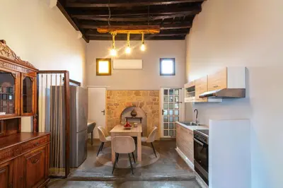 a kitchen with a table and a refrigerator at Colours - Old Town - Studios in Rhodes Town