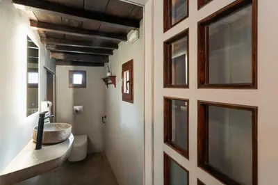 a bathroom with a sink next to a door at Colours - Old Town - Studios in Rhodes Town