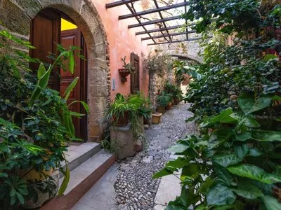 an outdoor pathway with plants and a building at Colours - Old Town - Studios in Rhodes Town