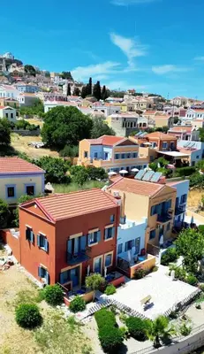 an aerial view of a city with houses at Taxiarchis in Symi