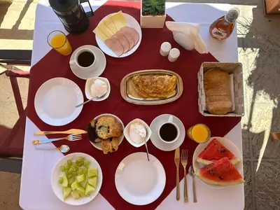 a table topped with plates of food and breakfast foods at Taxiarchis in Symi