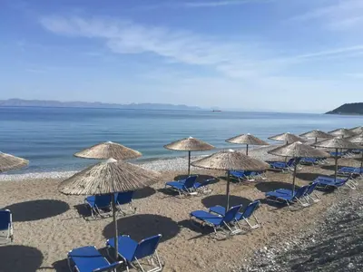 a group of chairs and umbrellas on a beach at Lito Hotel in Ixia
