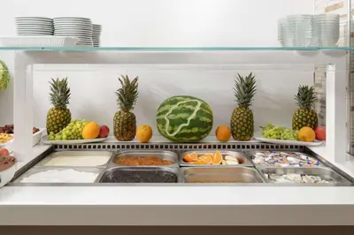 a refrigerator filled with lots of fruits and vegetables at Lito Hotel in Ixia