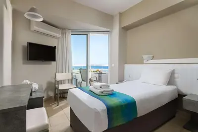 a bedroom with a bed with a view of the ocean at Lito Hotel in Ixia