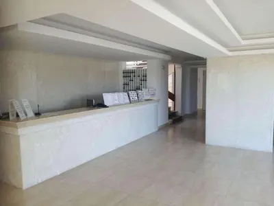 a lobby with a counter in a building at Lito Hotel in Ixia