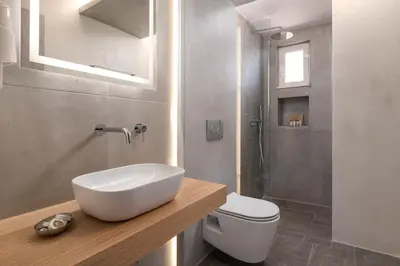 a bathroom with a sink and a toilet at L & C Boutique Apartments in Kremasti