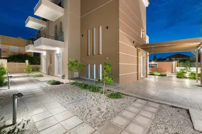 an exterior view of a house with a driveway at L & C Boutique Apartments in Kremasti