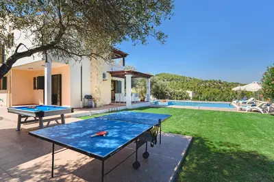 two ping pong tables in the backyard of a house at Seven Springs Villas Artemis Villa in Kolimbia