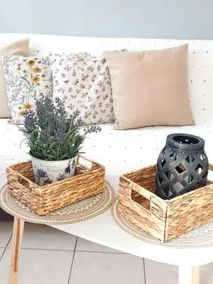 two baskets on a coffee table next to a couch with pillows at Anastasia's garden house in Ialyssos