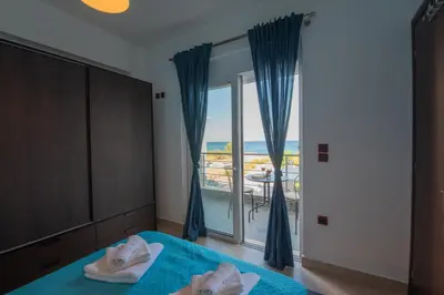 a bedroom with a bed and a window with a view at Aegiali Sea View Villa in Gennadi