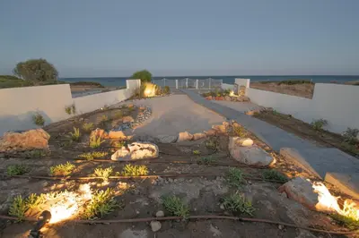 a pathway leading to the beach at dusk at Aegiali Sea View Villa in Gennadi