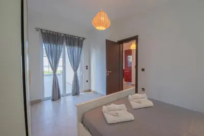 a bedroom with a bed with two towels on it at Aegiali Sea View Villa in Gennadi