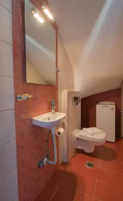 a bathroom with a sink and a toilet at Aegiali Sea View Villa in Gennadi