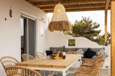 a dining room with a table and chairs at Villa Mamma Mia in Gennadi