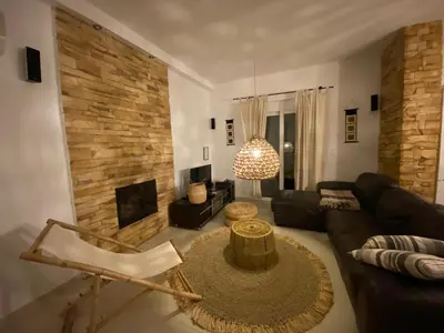 a living room with a couch and a table at Villa Mamma Mia in Gennadi