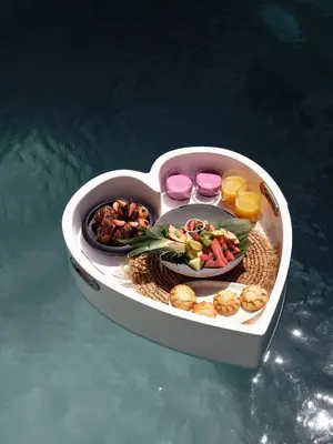 a heart shaped container filled with food in the water at Casa Cabana Boutique Hotel & Spa - Adults Only in Faliraki