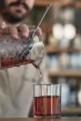 a person pouring a drink into a glass at Casa Cabana Boutique Hotel & Spa - Adults Only in Faliraki