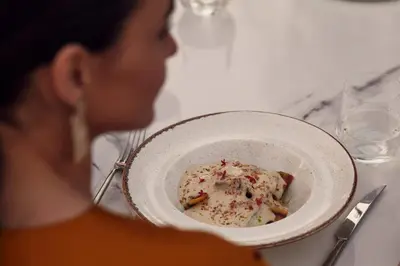 a woman sitting at a table with a bowl of food at Casa Cabana Boutique Hotel & Spa - Adults Only in Faliraki